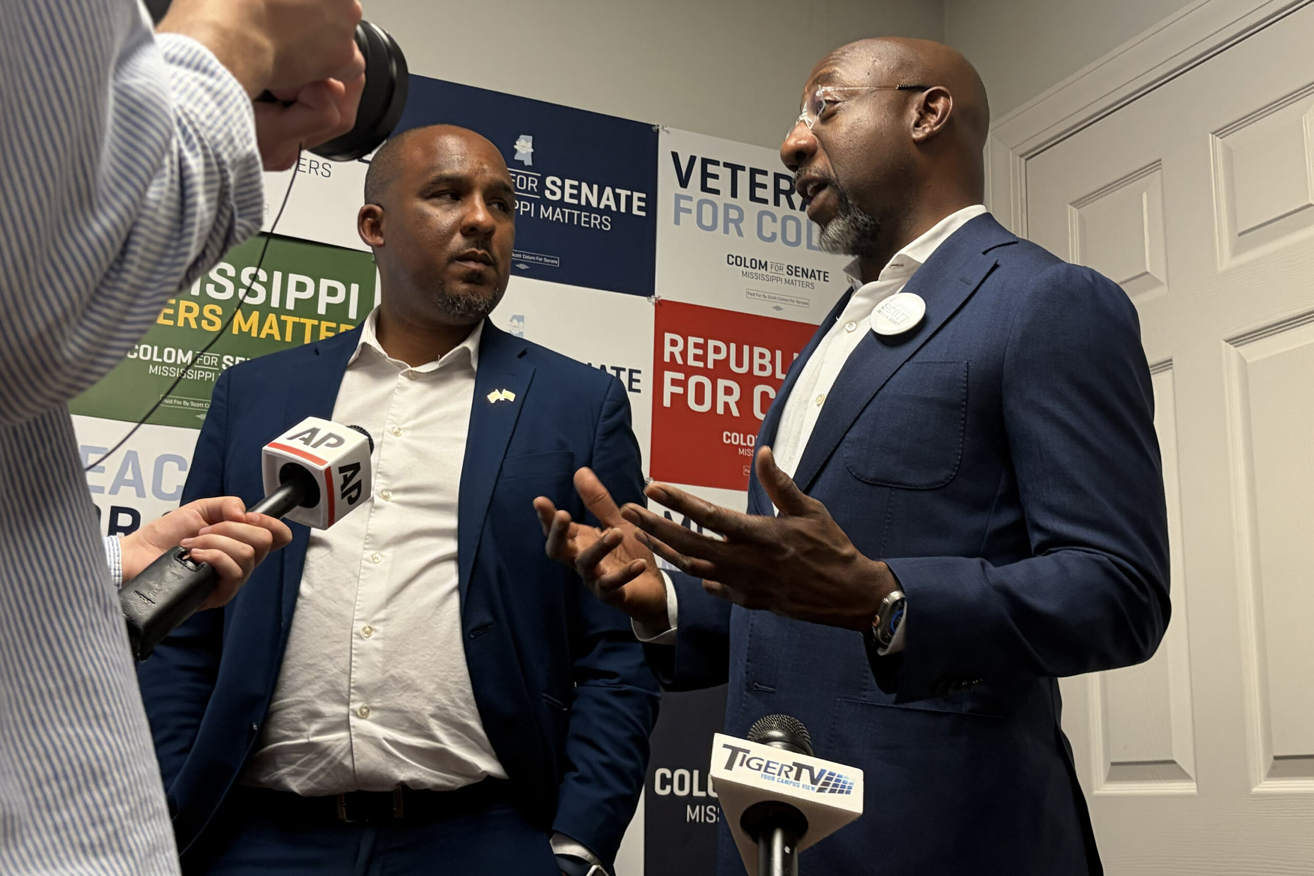Sen. Raphael Warnock and Democratic nominee for Senate in Mississippi Scott Colom address reporters in Jackson, Mississippi. 